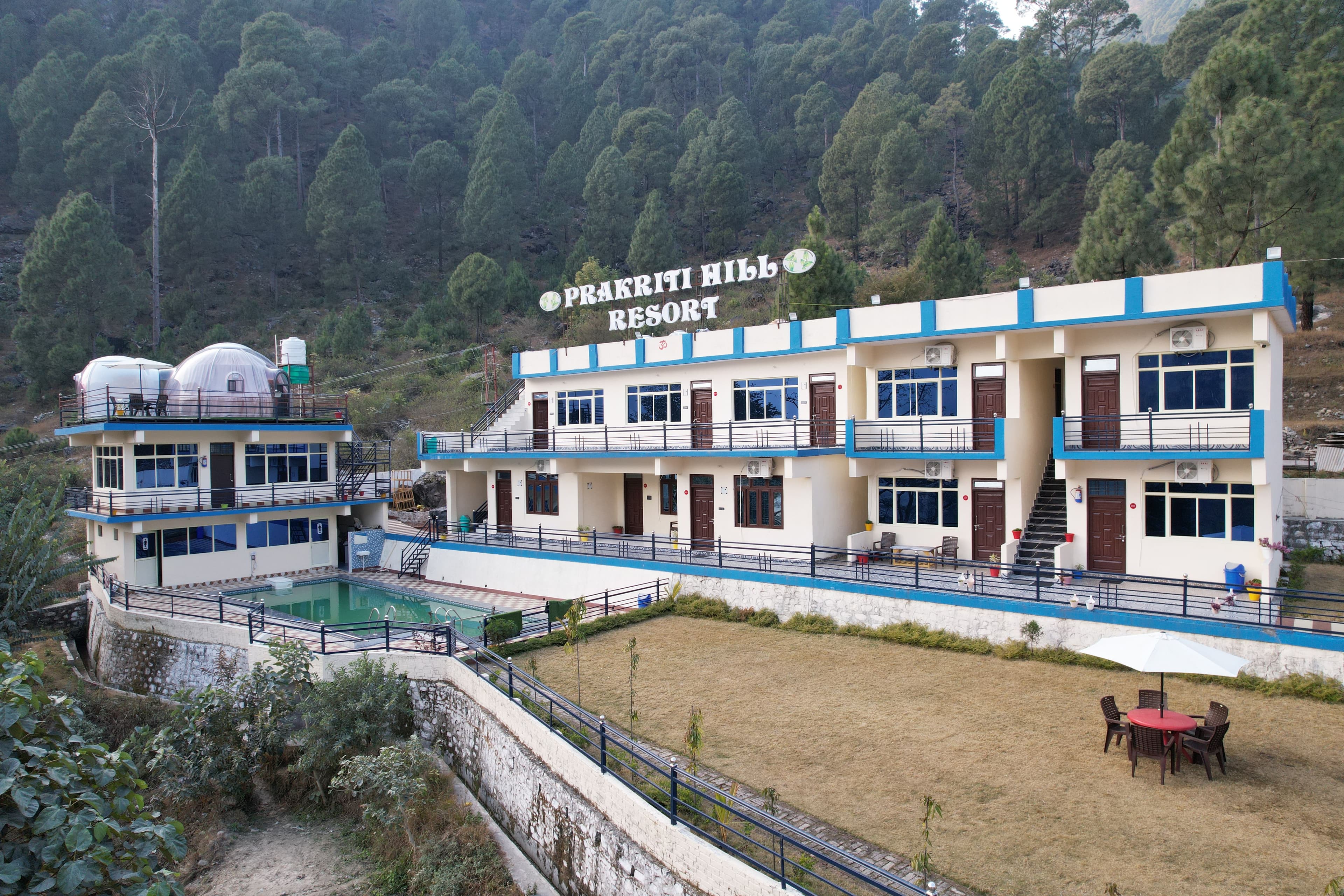 Resort facade with mountains in the backdrop